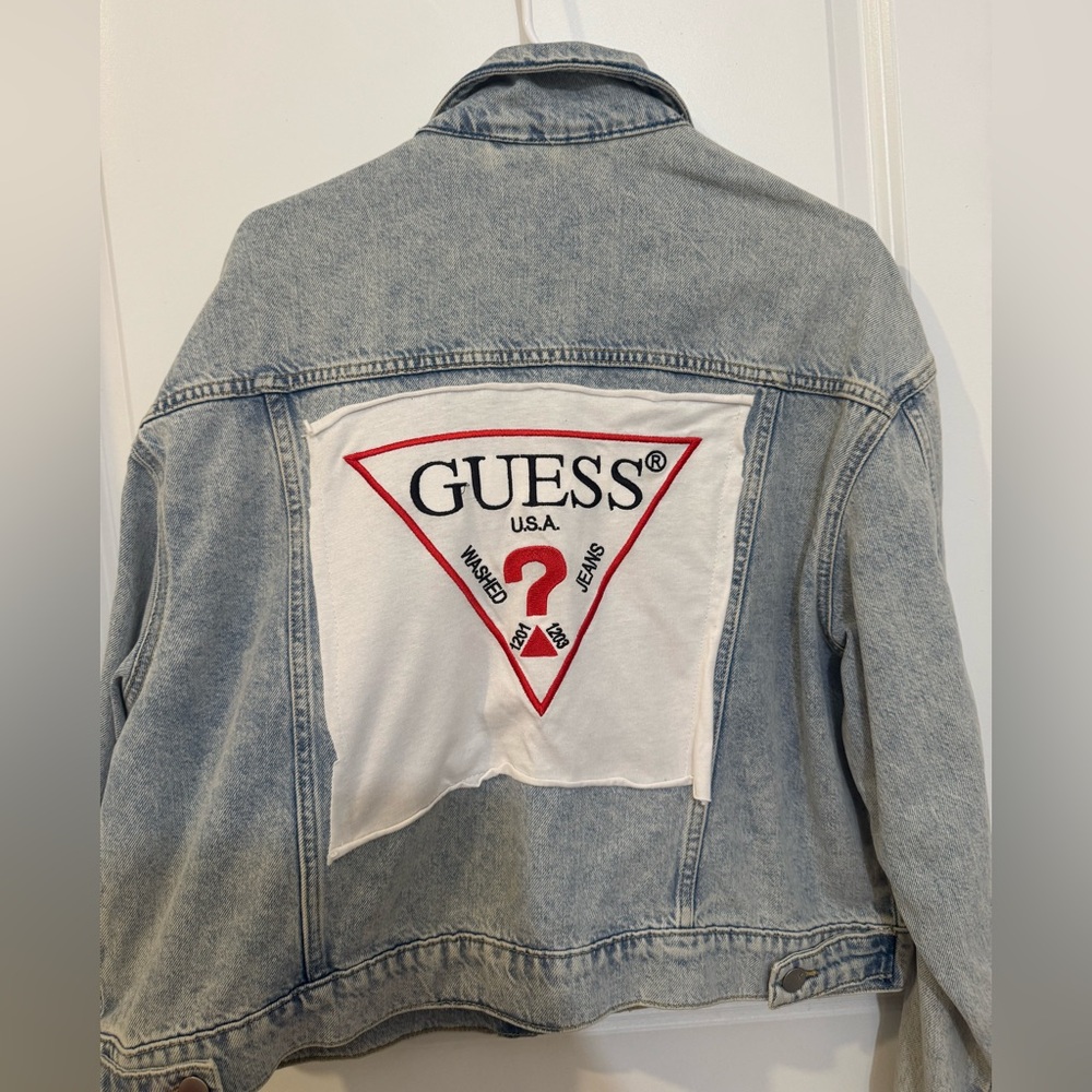 Vintage-style denim jacket with custom Guess logo patch sewn on the back.